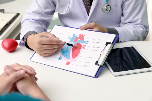 Doctor explaining heart to patient about details and risks operation. Healthcare and medical concept.