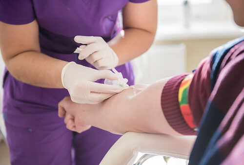 Nurse taking a patient's blood sample at lab. Nurse taking a patient's blood sample at lab.